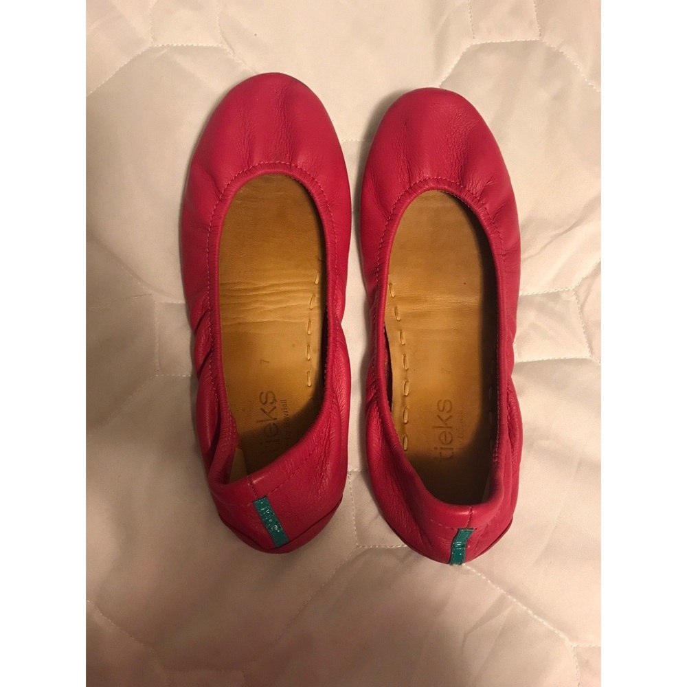 Pink Tieks flats.